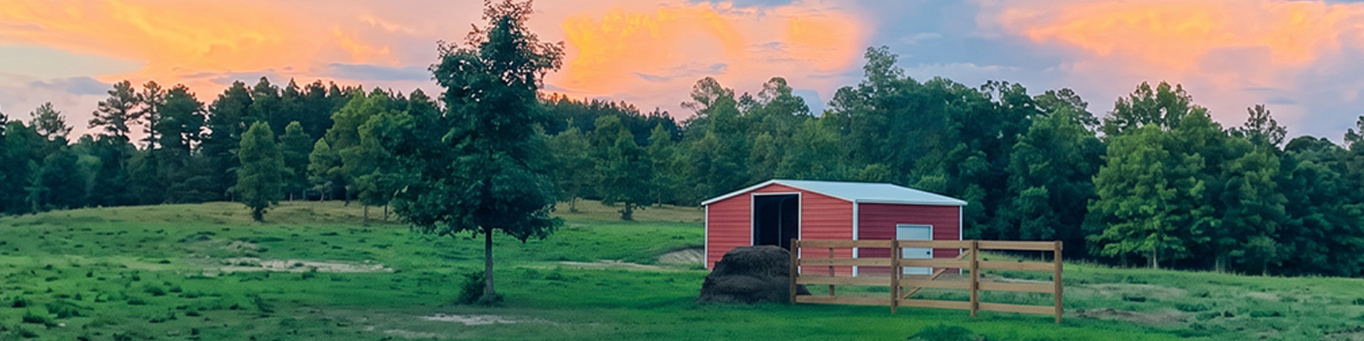 Red barn and pasture at the Equinovate Therapy Services farm in Bauxite at sunset