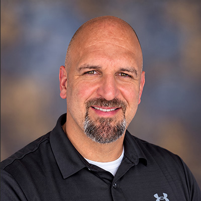Jeremy Cunningham of Red Garrison LLC smiles in a studio portrait.