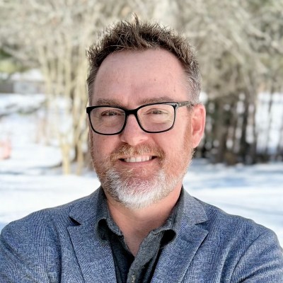 Mark McDougal of Red Garrison LLC smiles outdoors.